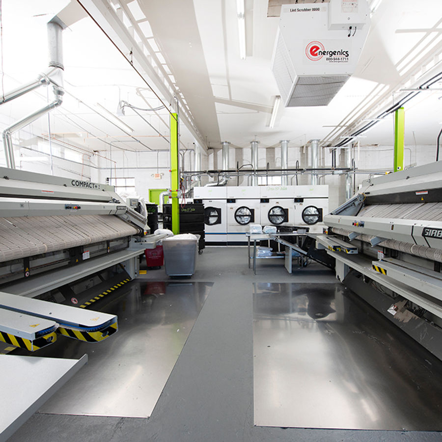Commercial washing machines at the laundry facility